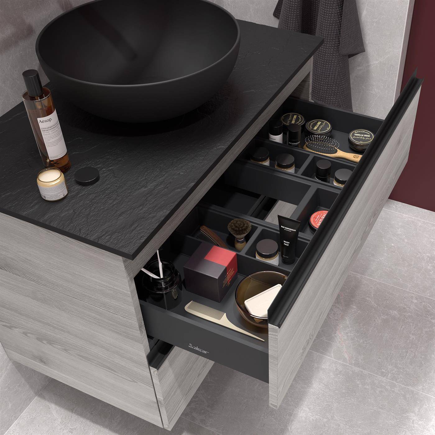 Modernes Badezimmerwaschtisch mit rundem schwarzem Aufsatzwaschbecken und offener Schubladenorganisatorbox mit Toilettenartikeln, Make-up und Grooming-Produkten.