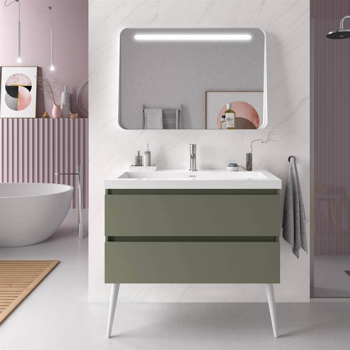 Modernes Badezimmer-Waschtisch mit rundem Spiegel und Wandleuchte über einem grünen Schrank und weißem Waschbecken, neben einer freistehenden Badewanne in einem Pastellinterieur.