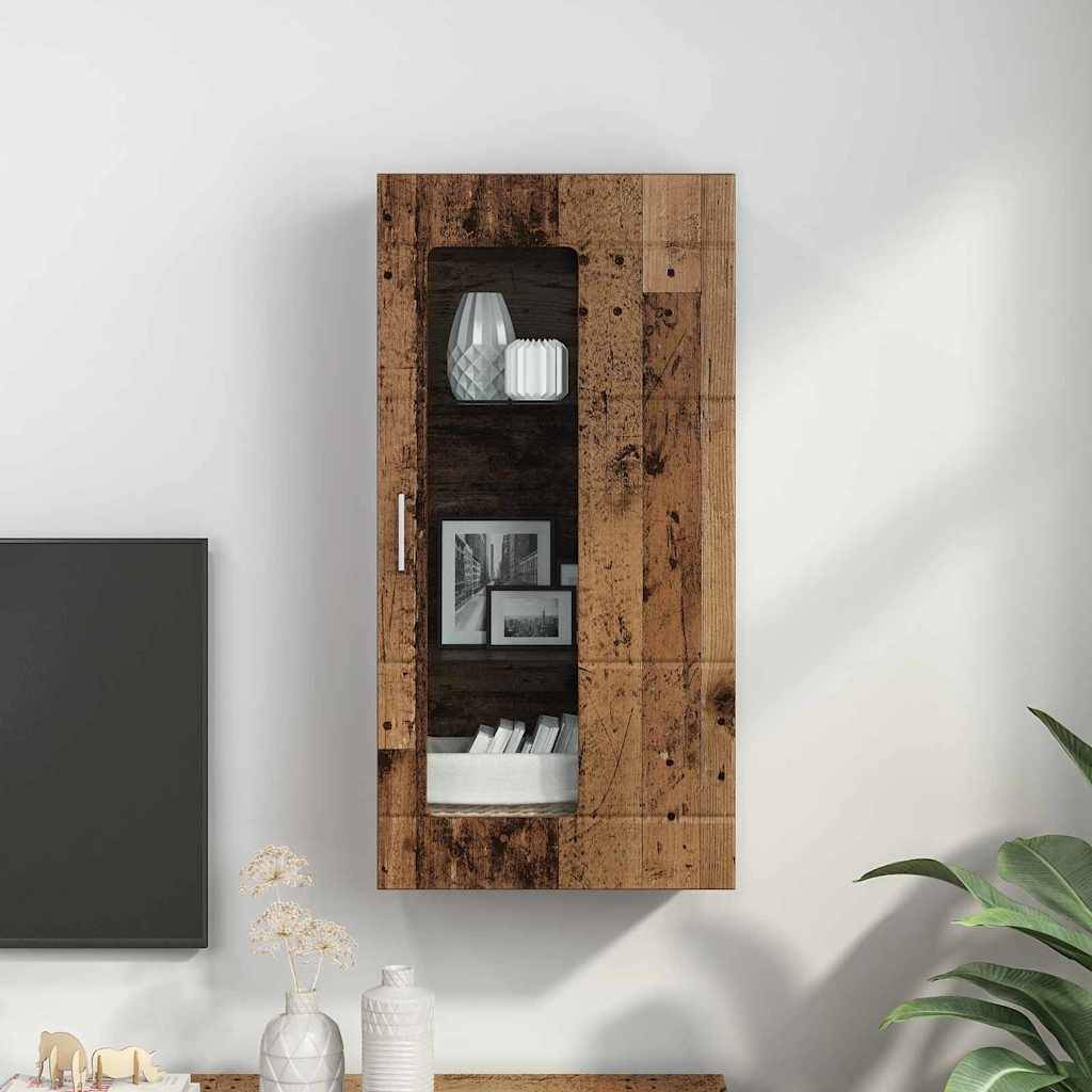 Ein rustikaler Holzwandschrank mit Glastür zeigt Dekorationsgegenstände, darunter Vasen und Bücher, positioniert über einem weißen Tisch mit Pflanzen.