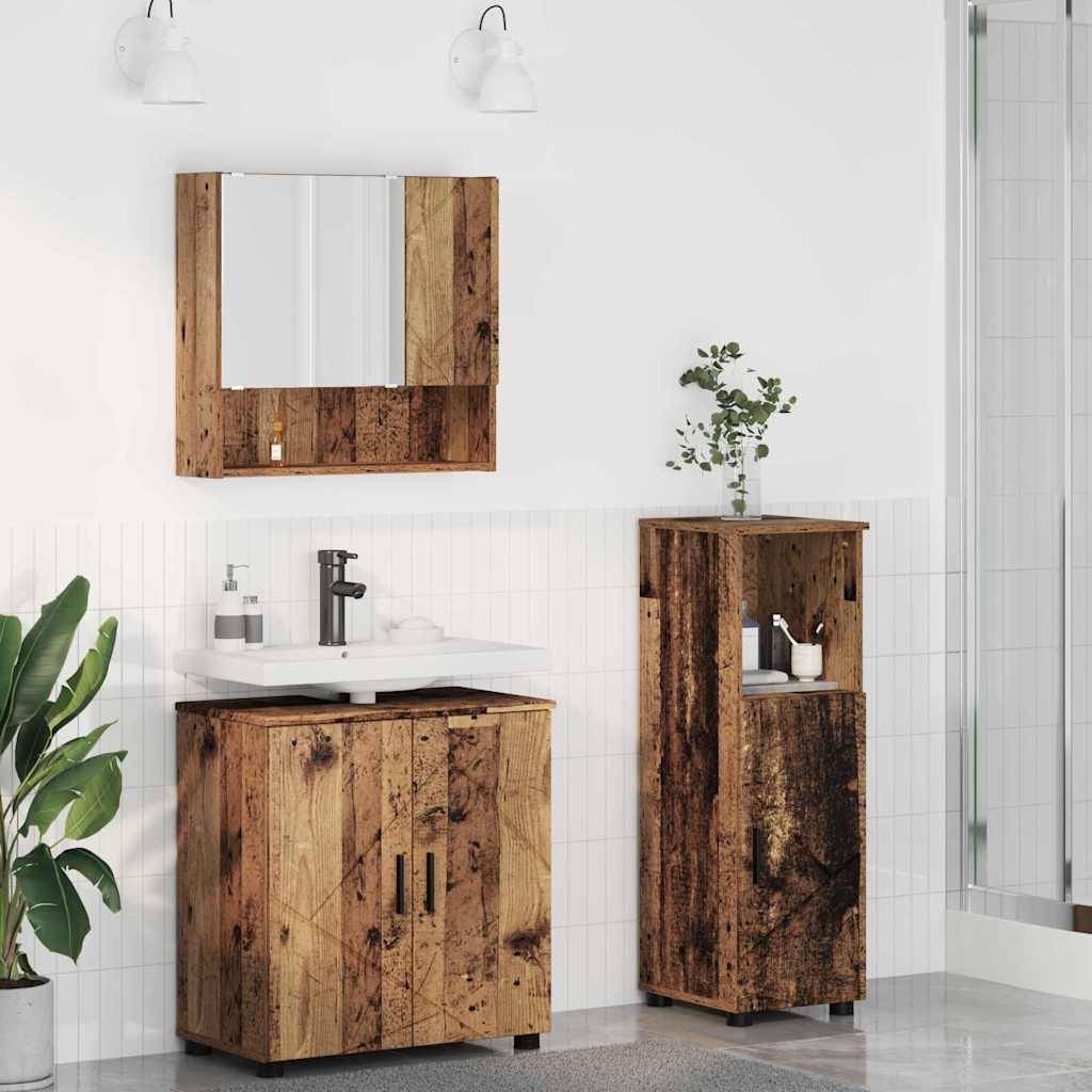 Ein rustikales Badezimmer mit Schränken aus recyceltem Holz, ausgestattet mit einer Spüle und einem Spiegel. Weiße Wände, ein grauer Boden und eine Topfpflanze sorgen für Kontrast.