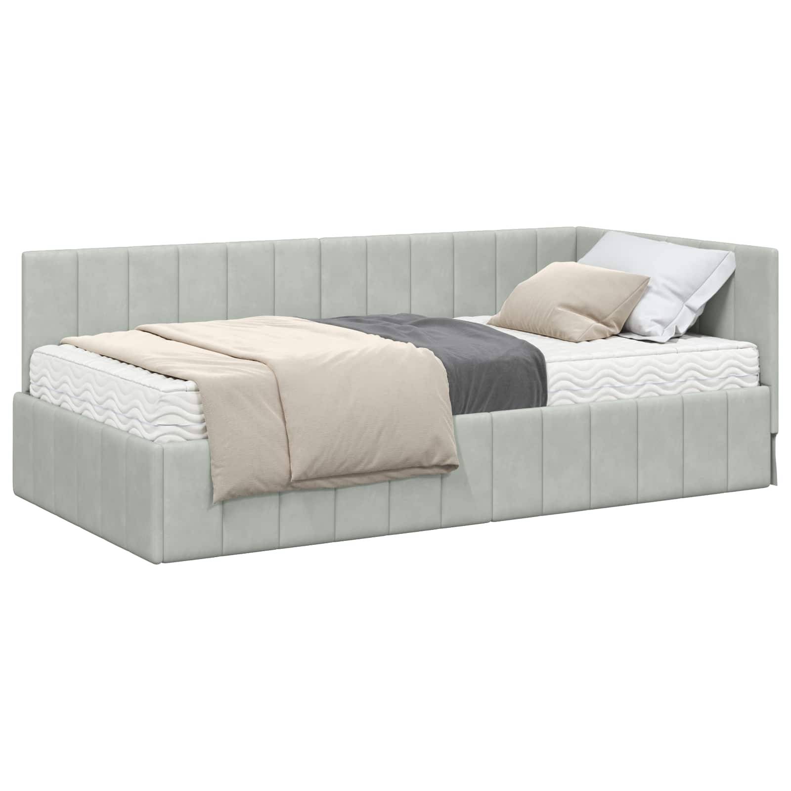 Ein grau gepolstertes Tagesbett mit einer Matratze, einer beigen Decke und zwei Kissen, eines grau und eines beige, ordentlich darauf platziert.