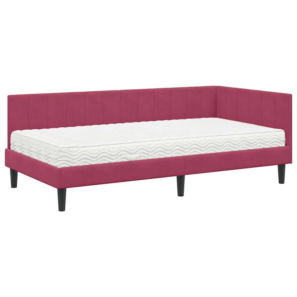 Rosa gepolstertes Tagesbett mit einer weißen Matratze, das ein schlankes, modernes Design mit einer getufteten Rückenlehne und schwarzen Beinen aufweist.