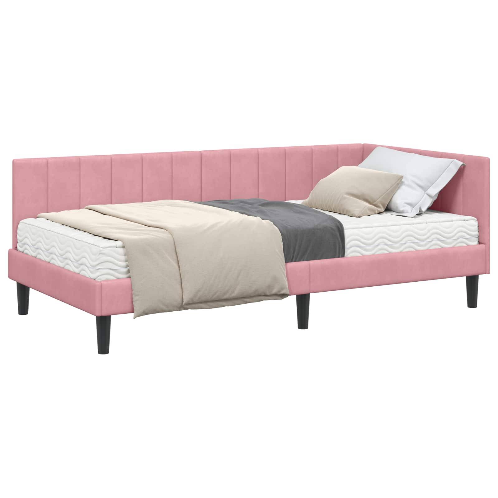 Pinke Eckbettstelle mit schwarzen Beinen, ausgestattet mit einer beigen Bettdecke, grauer Decke und weißen Kissen, die ein modernes und gemütliches Erscheinungsbild bietet.