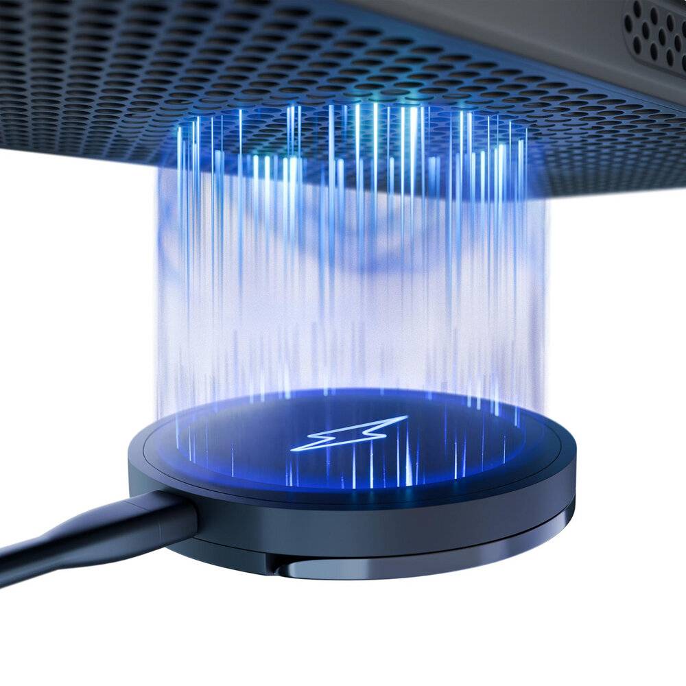 Ein drahtloses Telefonladegerät, das über ein Kabel angeschlossen ist, sendet einen blauen Lichtstrahl nach oben aus und zeigt damit die Stromübertragung auf ein darüber platziertes Gerät an.