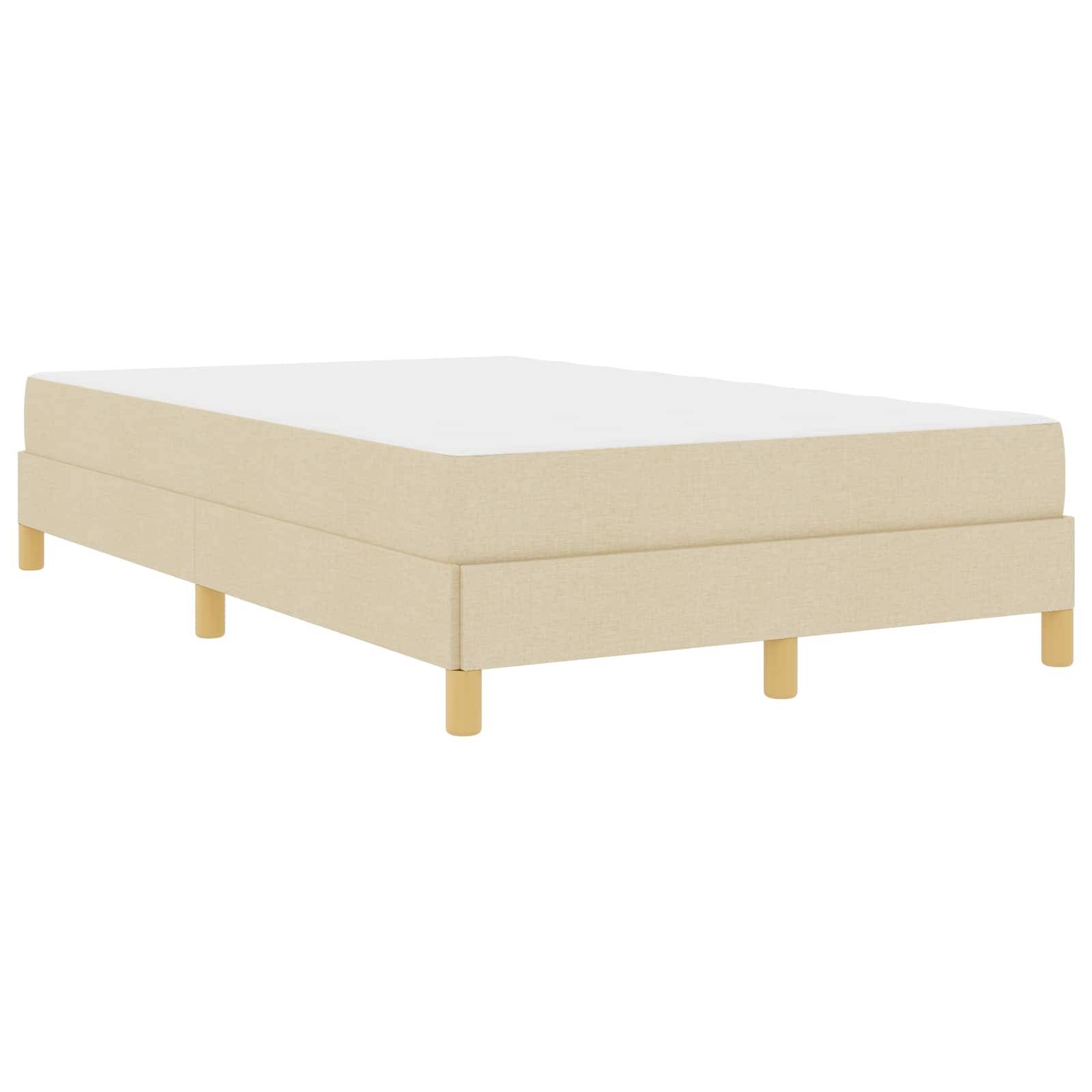 Ein beige gepolstertes Bett mit kurzen Holzbeinen, aus einem flachen Blickwinkel betrachtet, das sein einfaches, modernes Design und die neutrale Farbe hervorhebt.