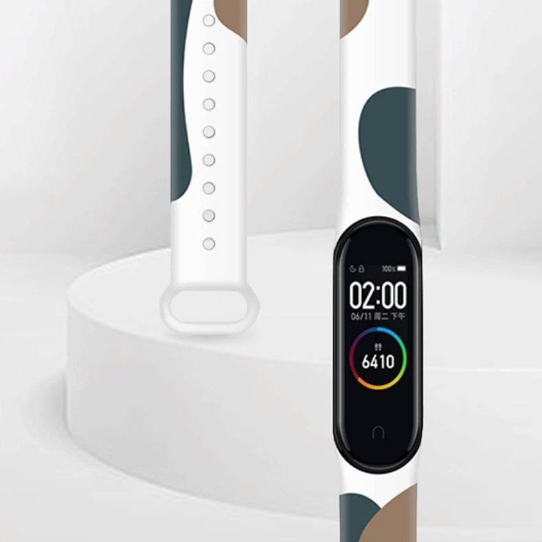 Ein eleganter Fitness-Tracker mit einem bunten abstrakten Design auf dem Band zeigt die Uhrzeit, das Datum, den Batteriestatus und 6.410 Schritte an.