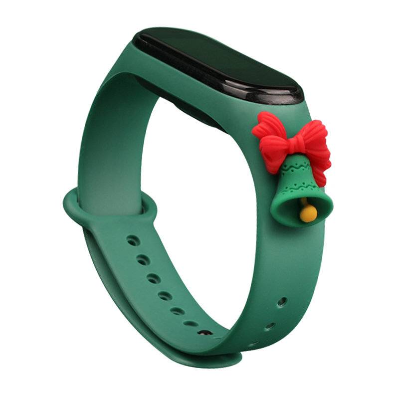 Eine grüne Smartwatch mit einem weihnachtsthematischen Dekorationsband mit einer roten Schleife und einer grünen Glocke.