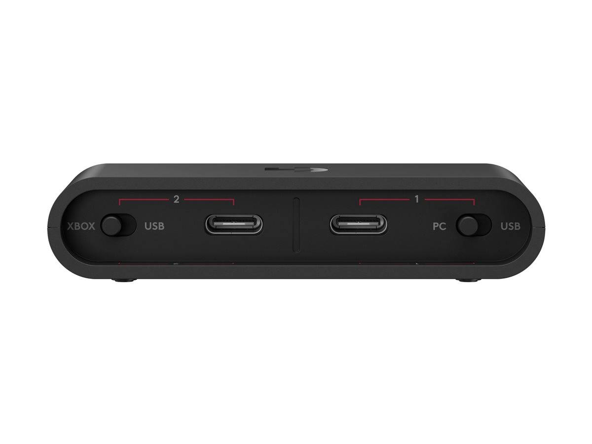 Schwarzer Adapter mit zwei USB-C-Anschlüssen und Modusschaltern mit der Bezeichnung Xbox/USB auf der linken Seite und PC/USB auf der rechten Seite.
