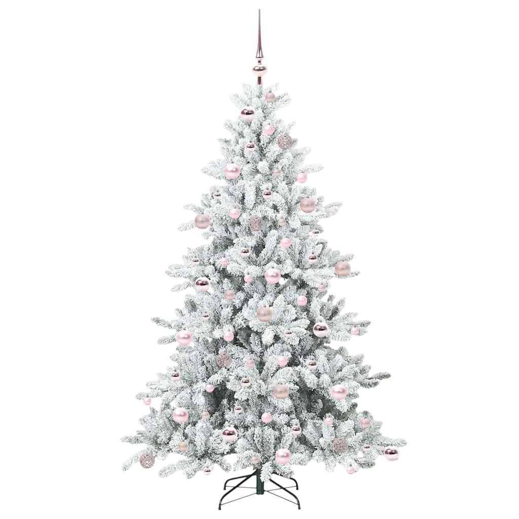 Ein mit Flausch versehener Weihnachtsbaum, geschmückt mit rosa und silbernen Weihnachtskugeln, gekrönt von einem metallfarbenen Spitzenschmuck, steht auf einer schwarzen Metallbasis.