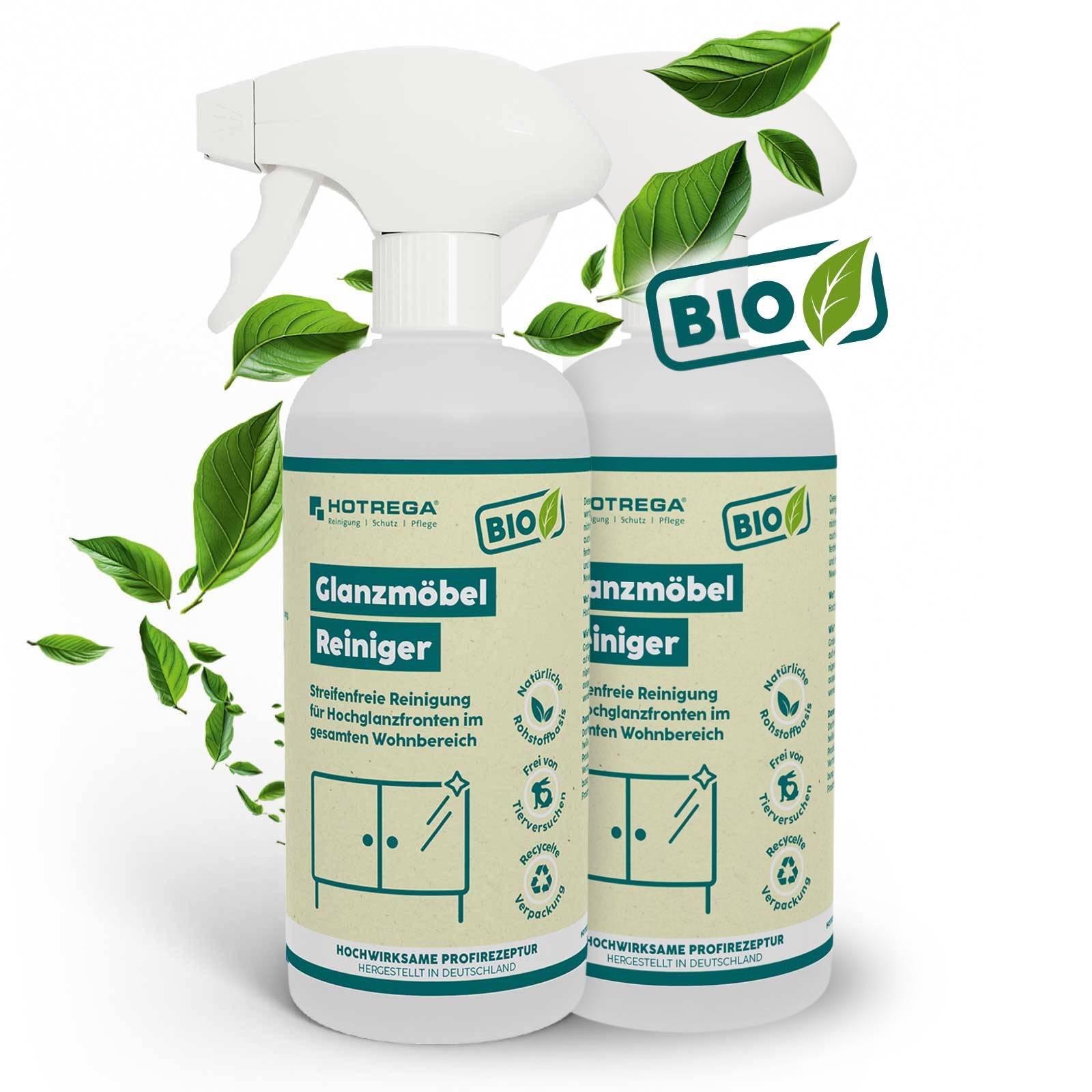 Zwei Flaschen HOTREGA Bio Glanzmöbel Reiniger, eine mit Sprühauslöser, gezeigt mit grünen Blättern und einem „BIO