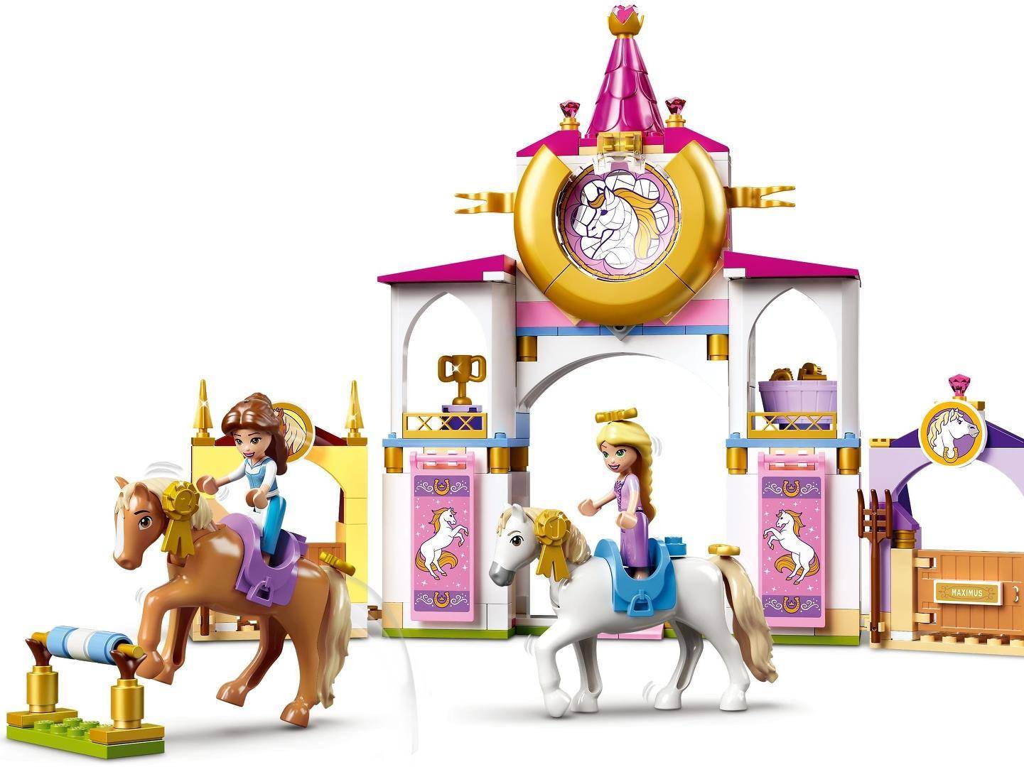 Zwei Spielzeugprinzessinnen auf Pferden vor einem farbenfrohen Spielset mit Einhornschloss mit Türmen, Uhr und Torwölbung.