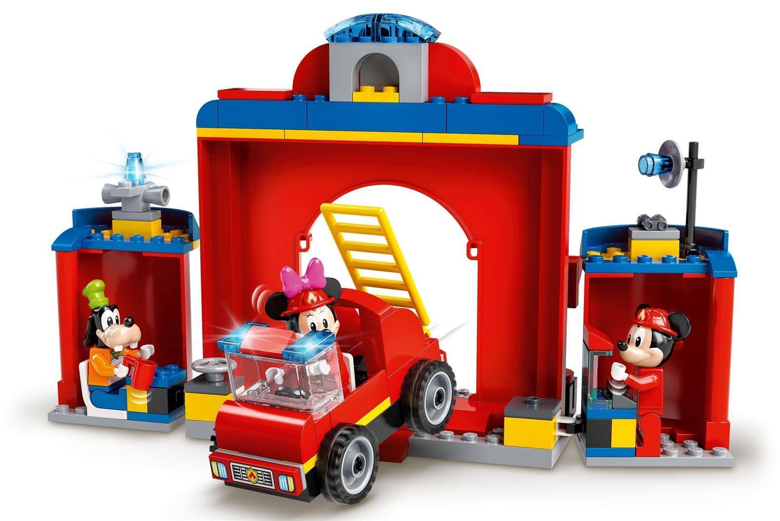 LEGO-Feuerwehrstation-Spielset mit einem roten Feuerwehrauto, das herauspfährt, einer Feuerwehrmann-Minifigur im Auto und Mickey- und Minnie-Figuren in Nebenstationen.