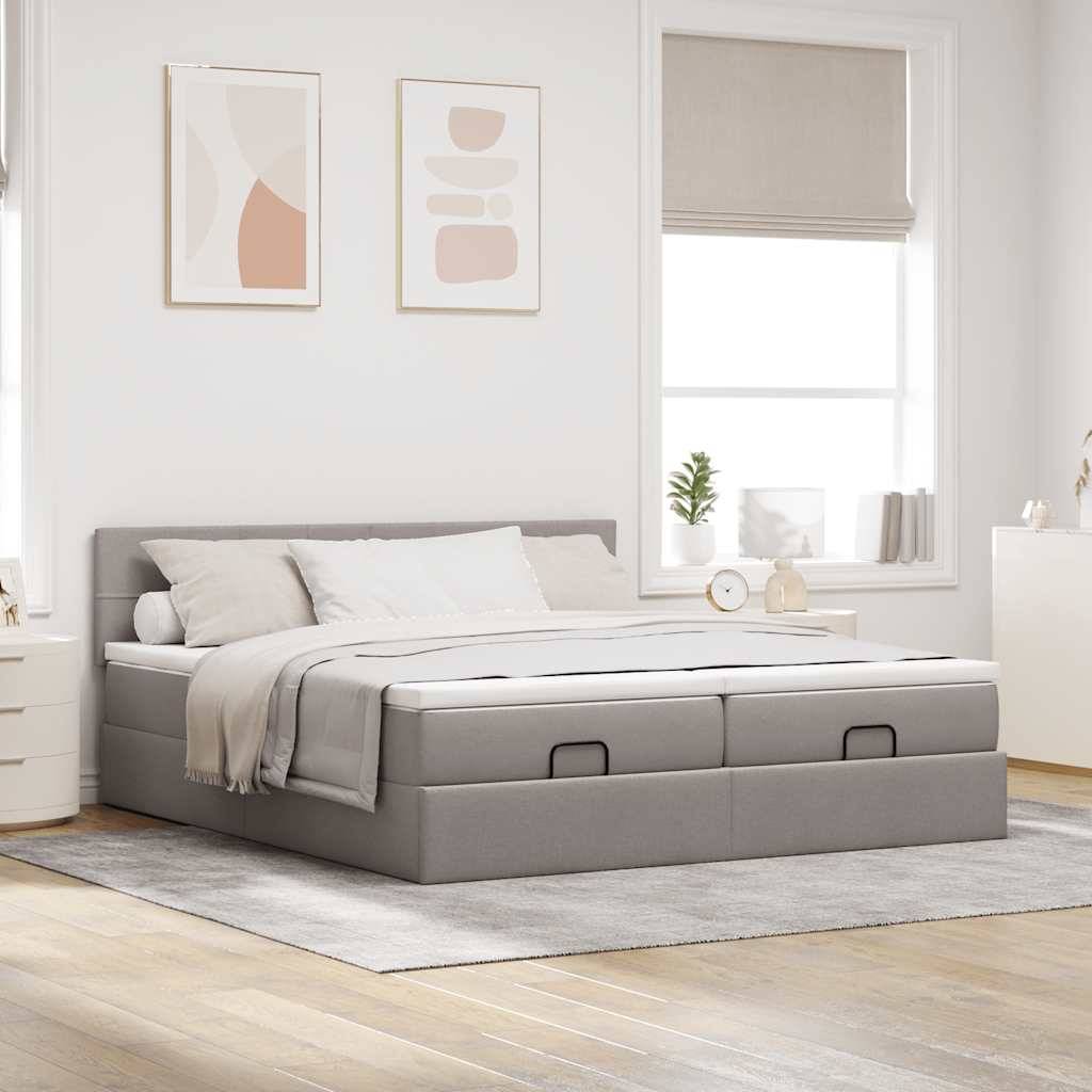 Ein modernes Schlafzimmer mit einem grau gepolsterten Bett, weißer Bettwäsche und weichen Kissen. Die minimalistische Dekoration umfasst abstrakte Kunstwerke und eine kleine Pflanze auf einem Nachttisch.