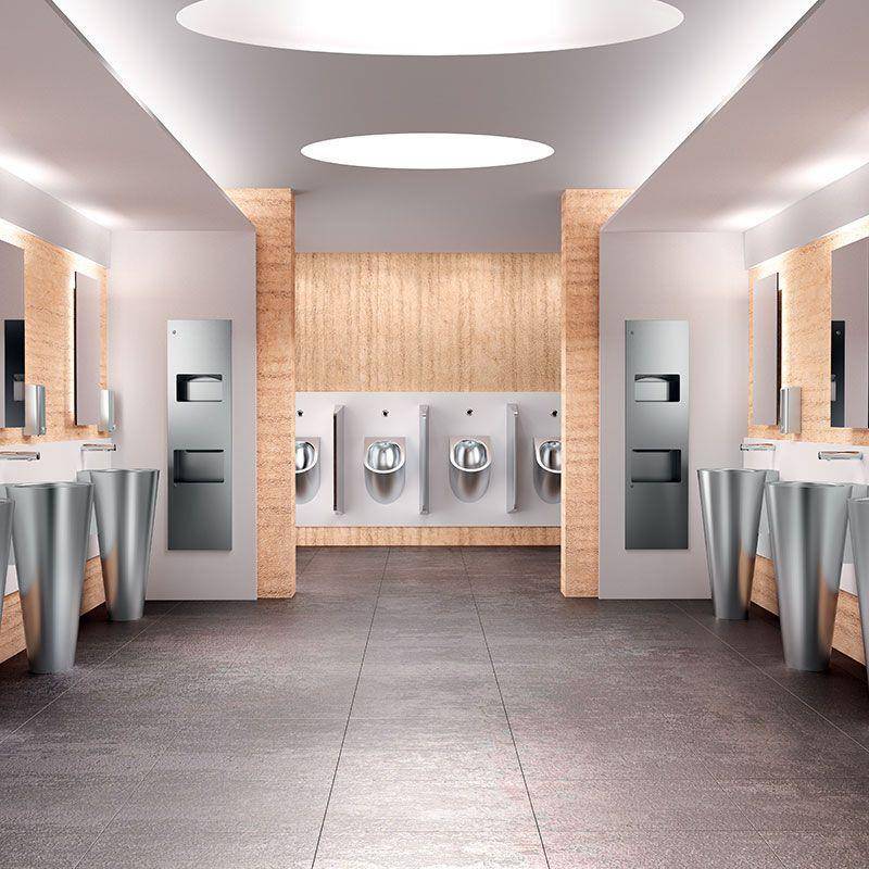 Moderner Sanitärraum mit verspiegelten Waschbecken auf beiden Seiten und symmetrisch angeordneten Edelstahl-Urinalen an der hinteren Wand.
