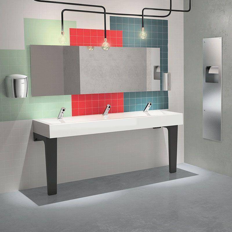 Modernes Badezimmer mit einem langen weißen Waschbecken, drei Wasserhähnen, großem Spiegelschrank und farbenfrohen Wandpaneelen in Grün, Rot und Blau.