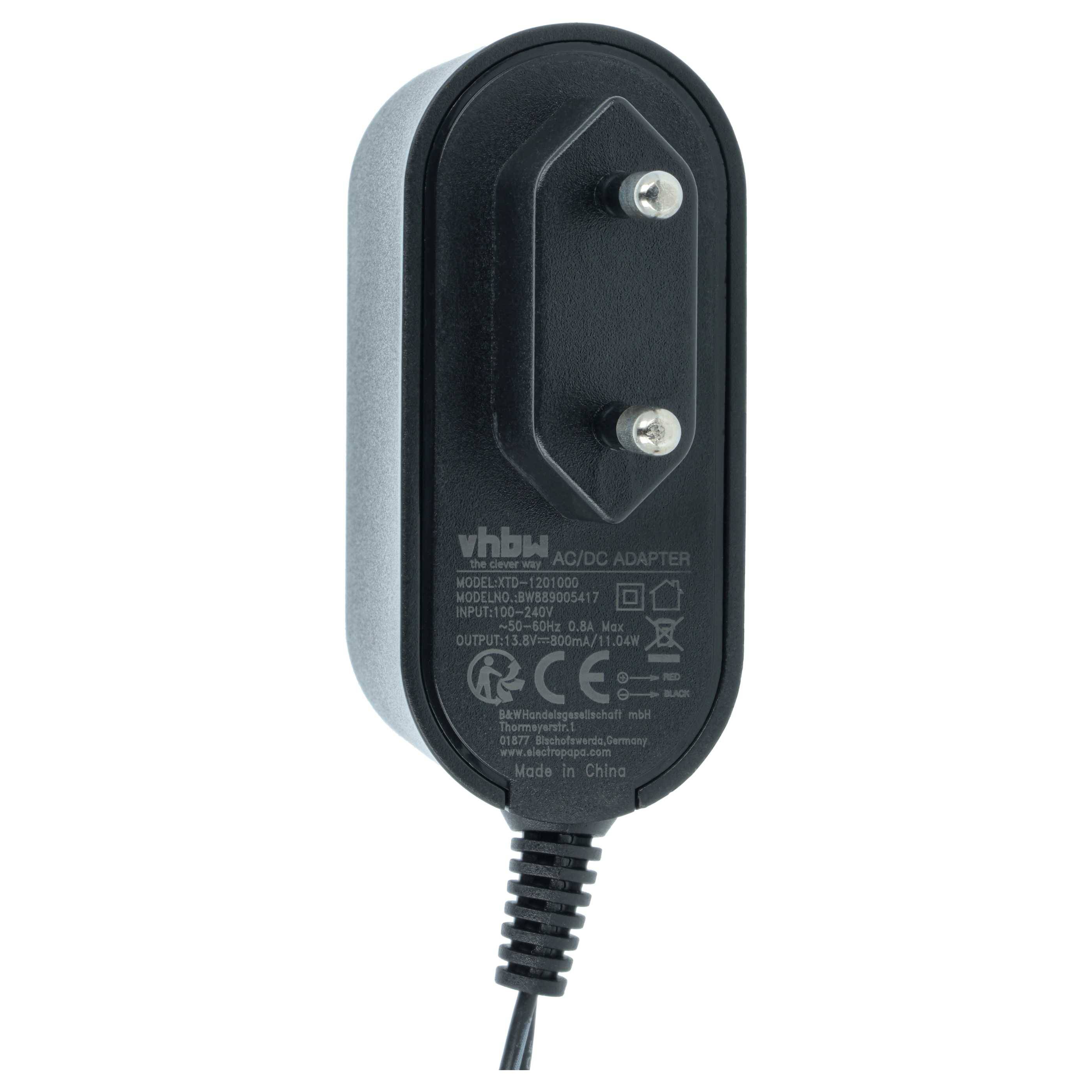 Ein schwarzes AC/DC-Netzteil mit zwei Stiften, Modell 'vhby' 120100U, liefert 12V 1A.