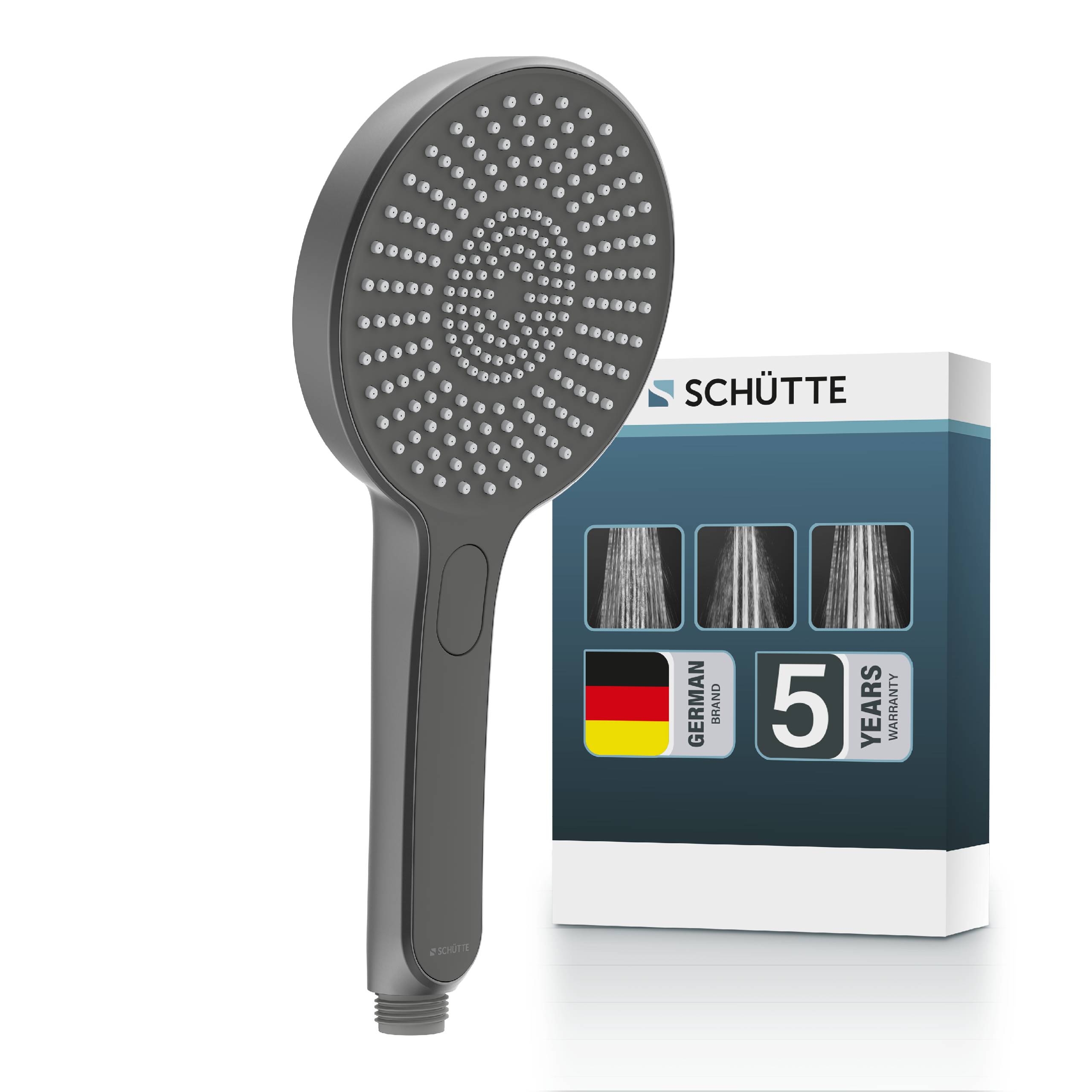 Ein dunkelgrauer tragbarer Duschkopf vor seiner Schütte-Produktbox, die ein deutsches Herstellungsgarantie-Etikett für 5 Jahre und Bilder von Sprüheinstellungen zeigt.