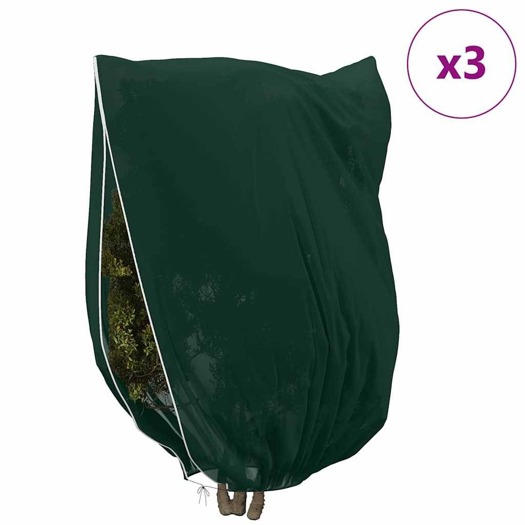 Grüne Gartenmöbel-Abdeckung über Stühlen drapiert; weiße Einfassung sichtbar, mit einem kleinen Pflanzenpatch darunter. 'x3' in einem lila Kreis.