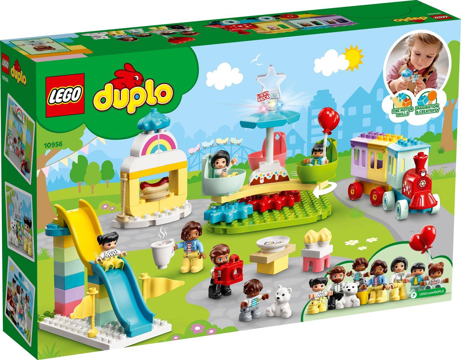 Eine farbenfrohe LEGO Duplo Spielzeugschachtel zeigt verschiedene Bauszenen, darunter ein Karnevalsthema mit einer Rutsche, einem Zug und spielerischen Kindern.