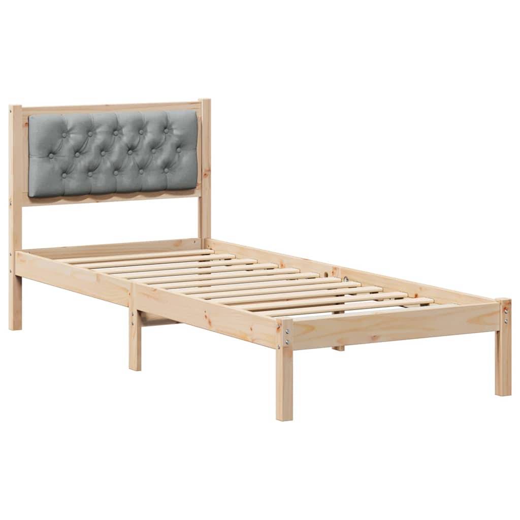Ein Holz-Einzelbettgestell mit Lattenrost und gepolstertem, grau abgestepptem Kopfteil.