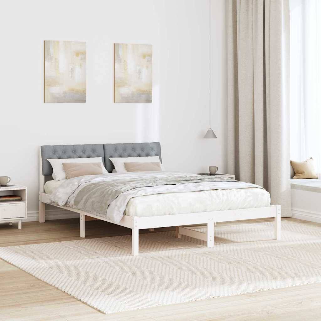 Ein modernes Schlafzimmer mit einem Doppelbett, grauem Kopfteil und heller Bettwäsche. Zwei abstrakte Gemälde hängen darüber. Weiches Licht und eine Fensterbank verstärken den luftigen Eindruck.