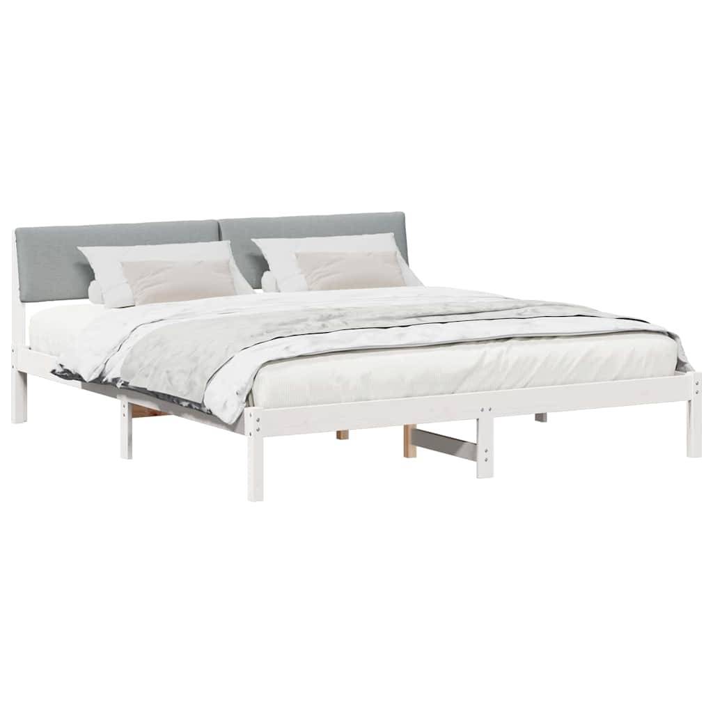 Ein weißes und graues Bett mit schlichtem Design, ausgestattet mit einem gepolsterten Kopfteil und zwei Kissen. Der Rahmen des Bettes ist minimalistisch und modern.