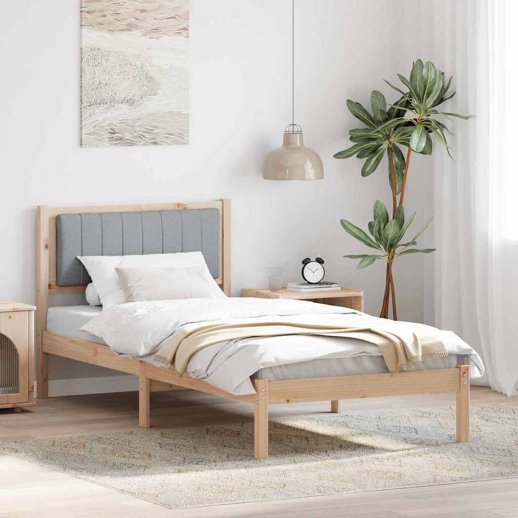 Ein minimalistisches Schlafzimmer mit einem Bettgestell aus Holz, einem hellgrauen Kopfteil, weißer Bettwäsche, einer beigen Decke, einem Nachttisch mit einer Lampe und einer Topfpflanze.