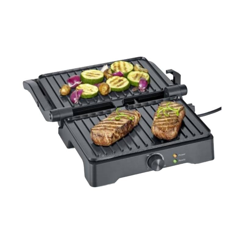 Ein elektrischer Grill mit zwei gebratenen Steaks auf der einen Seite und geschnittenen Gemüsesorten, darunter Zucchini und Zwiebeln, auf der anderen Seite.