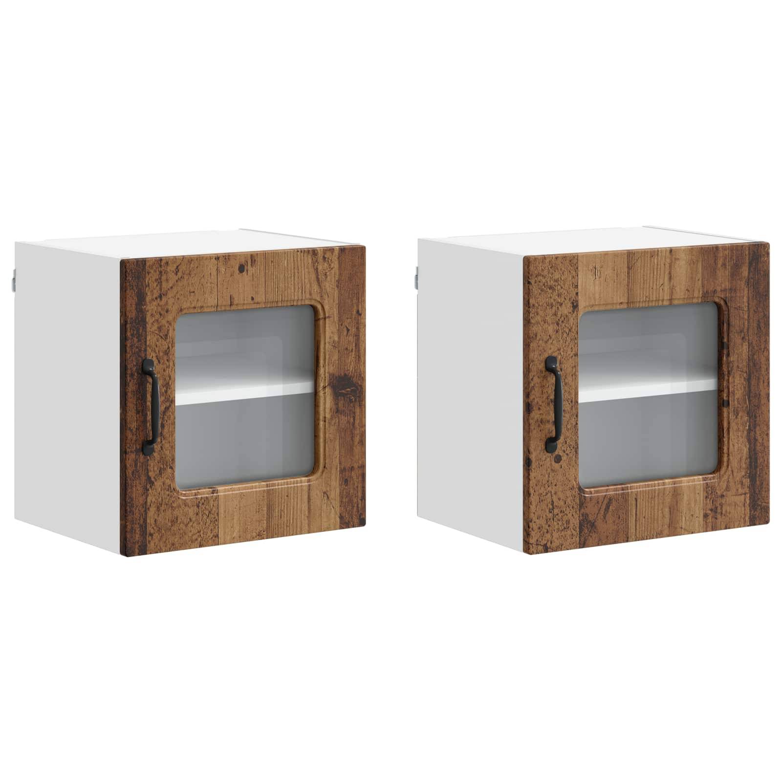 Zwei kleine weiße und holzfarbene Wandschränke mit Glastüren und schwarzen Griffen, geeignet für Küchen- oder Badezimmerspeicher.