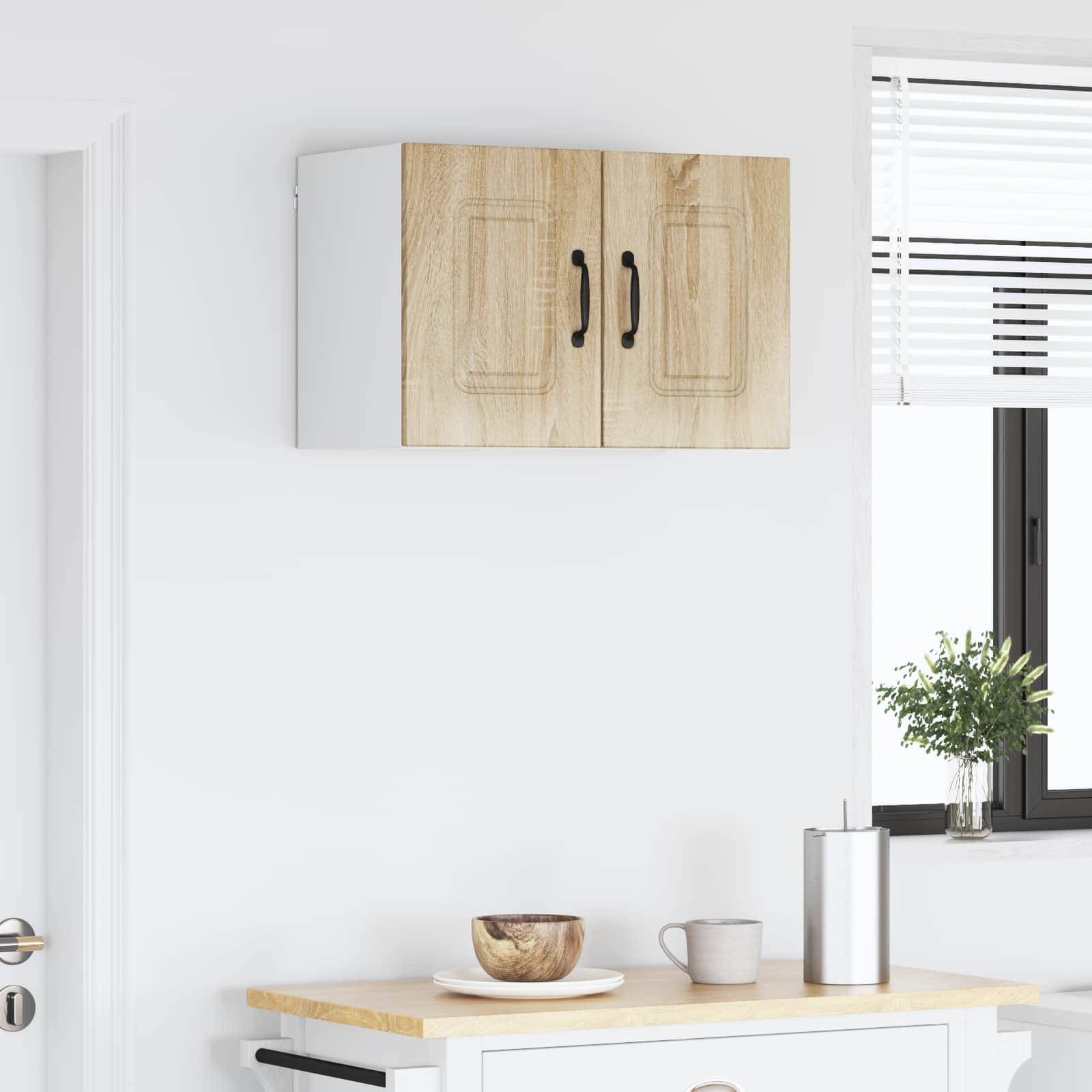 Eine moderne Küchenszene mit einer Holzarbeitsplatte, einer kleinen Pflanze, einer Holzschüssel und einem Metallbecher darauf. Ein Küchenschrank und ein Fenster sind sichtbar.