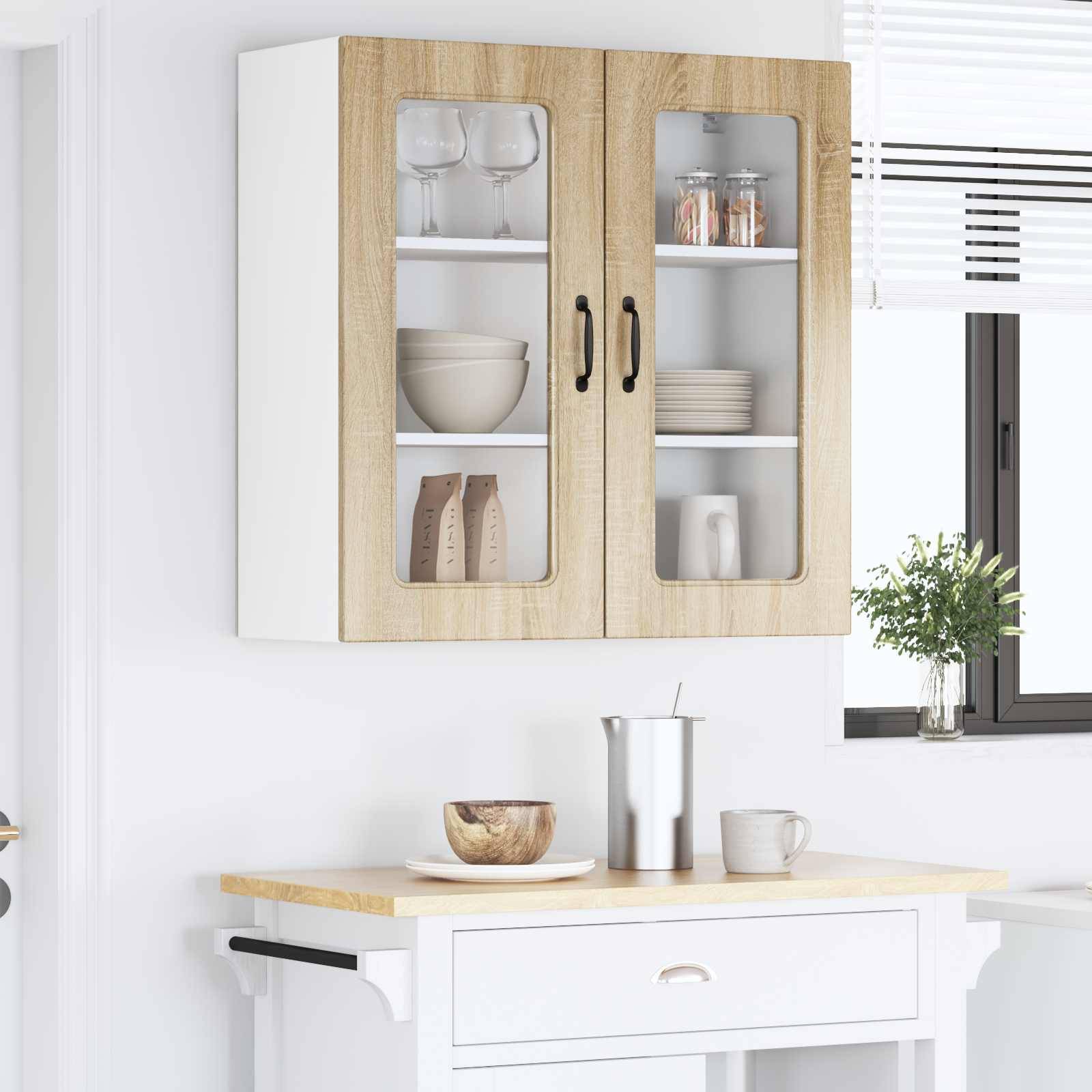 Ein weißer Küchenschrank mit Glastüren gibt Tassen und Gläser im Inneren preis. Darunter trägt eine Arbeitsplatte einen Teller, einen Becher und eine Kaffeekanne.