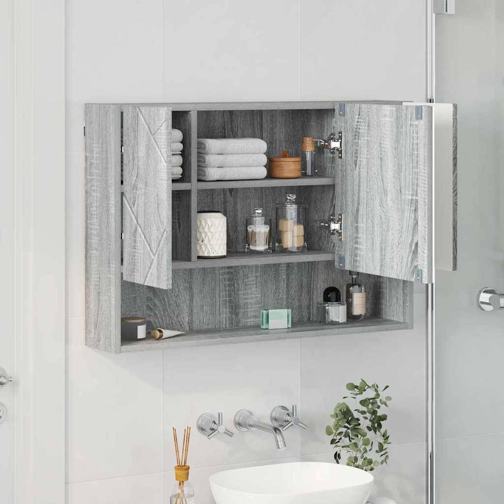 Modernes Badezimmer mit offenem grauen Holzschrank, der Handtücher, Toilettenartikel und Spiegel zeigt. Weißes Waschbecken darunter, mit Pflanzen und Zahnbürsten.