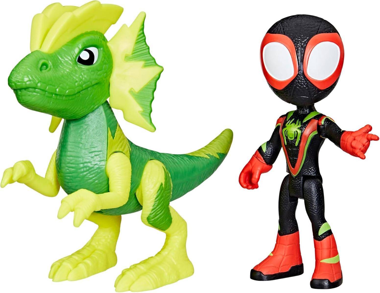 Zwei Spielzeug-Actionfiguren: ein grüner Dinosaurier mit gelben Akzenten und eine schwarz-rote Spider-Man-ähnliche Figur, die nebeneinander auf weißem Hintergrund stehen.