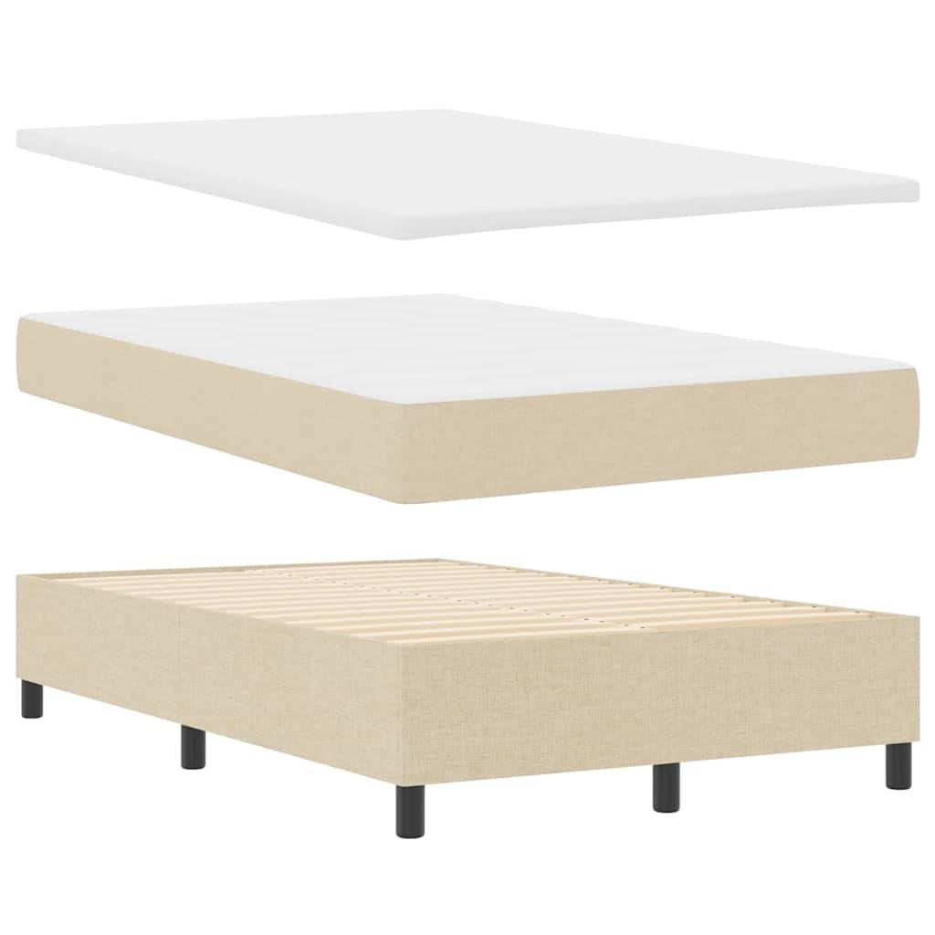 Schaumstoffmatratze mit drei Schichten: eine weiße Schaumstoff-Auflage, ein beiger Matratzenaufleger und eine beige stoffbezogene Bettunterlage.