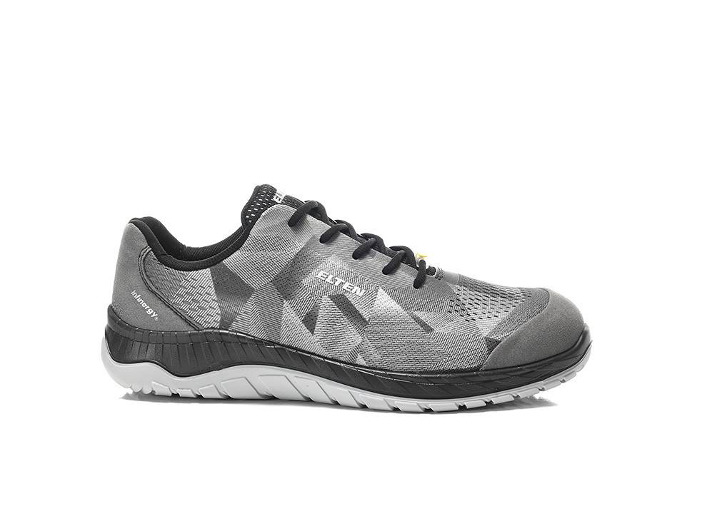 Ein grauer Sportschuh mit geometrischem Muster, ausgestattet mit schwarzen Schnürsenkeln und einer weißen Sohle, entwickelt für Komfort und Leistung.