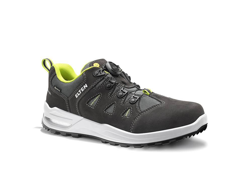 Ein schwarzer und grauer Sneaker mit weißer Sohle, ausgestattet mit limettenfarbenen Akzenten, zwei Zugschlaufen und einer Markenetikette 'ELTEN'.