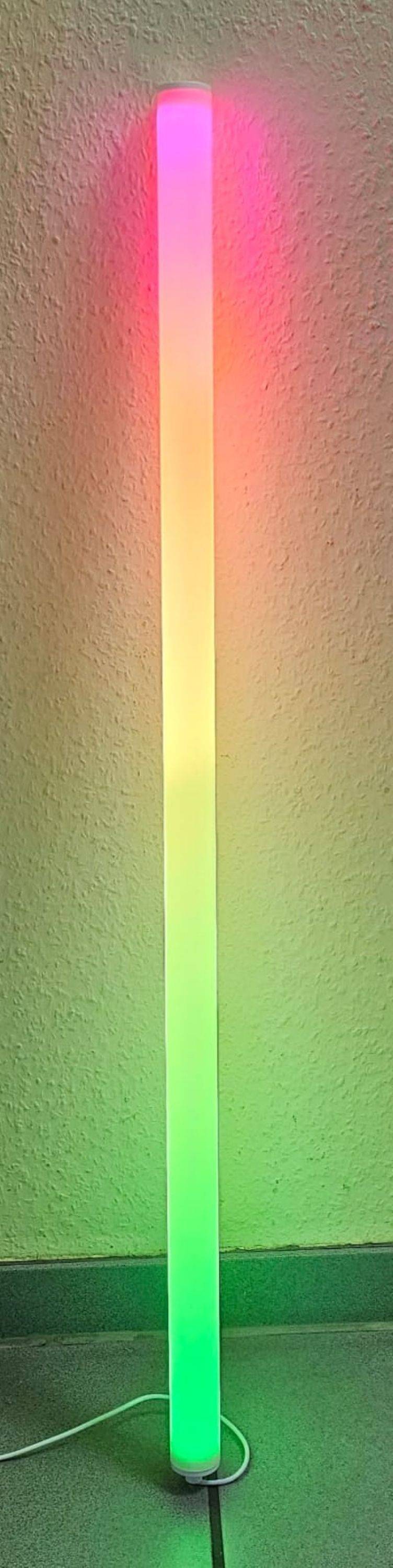 Eine strukturierte Wand wird von farbigen Lichtverläufen beleuchtet, die von warmem Orange auf der linken Seite zu lebendigem Grün auf der rechten Seite übergehen.