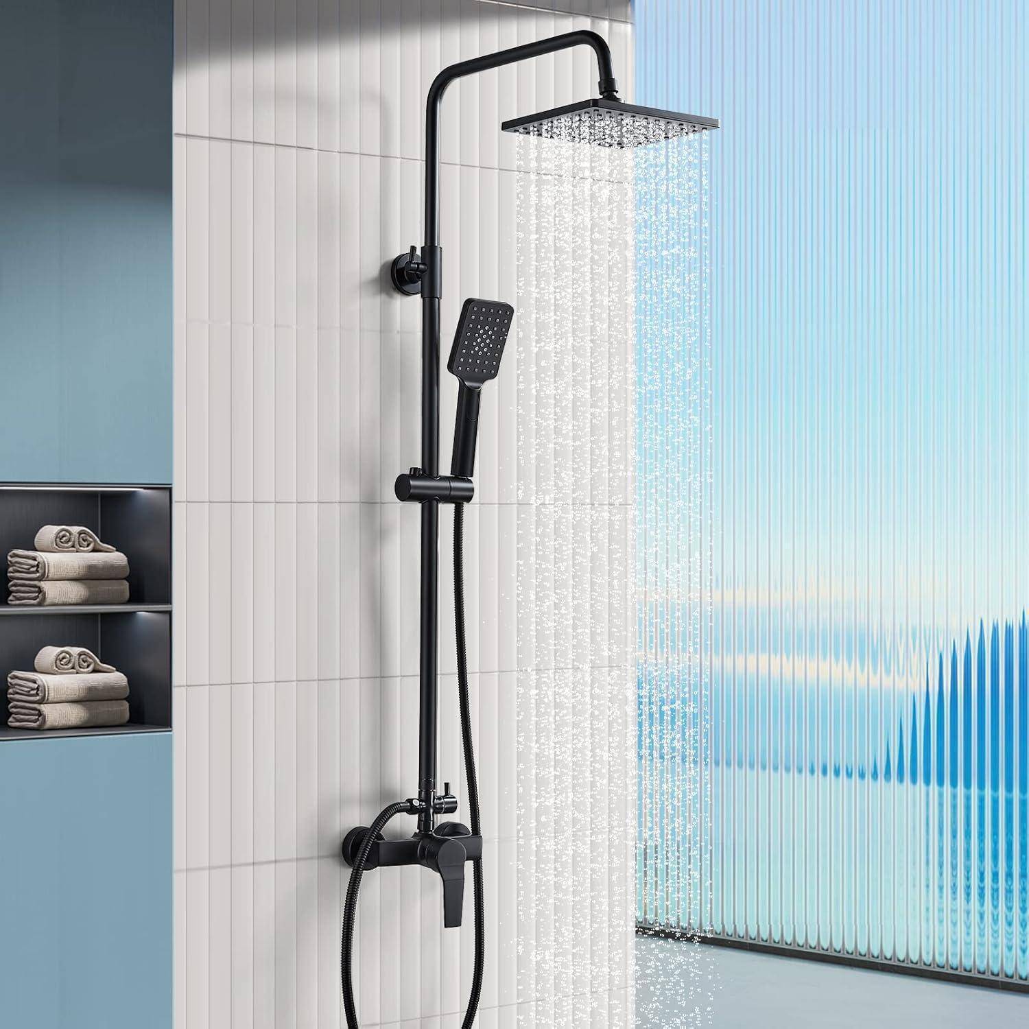 Ein moderner schwarzer Duschkopf mit Wasserfall-Brause in einem gefliesten Badezimmer. Weiches Licht fällt durch ein Milchglassfenster; gefaltete Handtücher sind in der Nähe gestapelt.