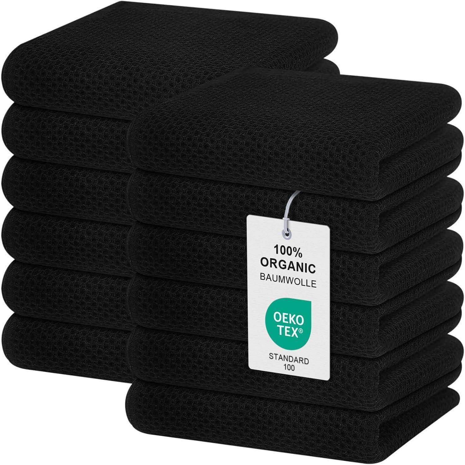 Ein Stapel schwarzer Baumwoll-Waschlappen mit einem Etikett, auf dem steht „100% Biologische Baumwolle, OEKO TEX Standard 100
