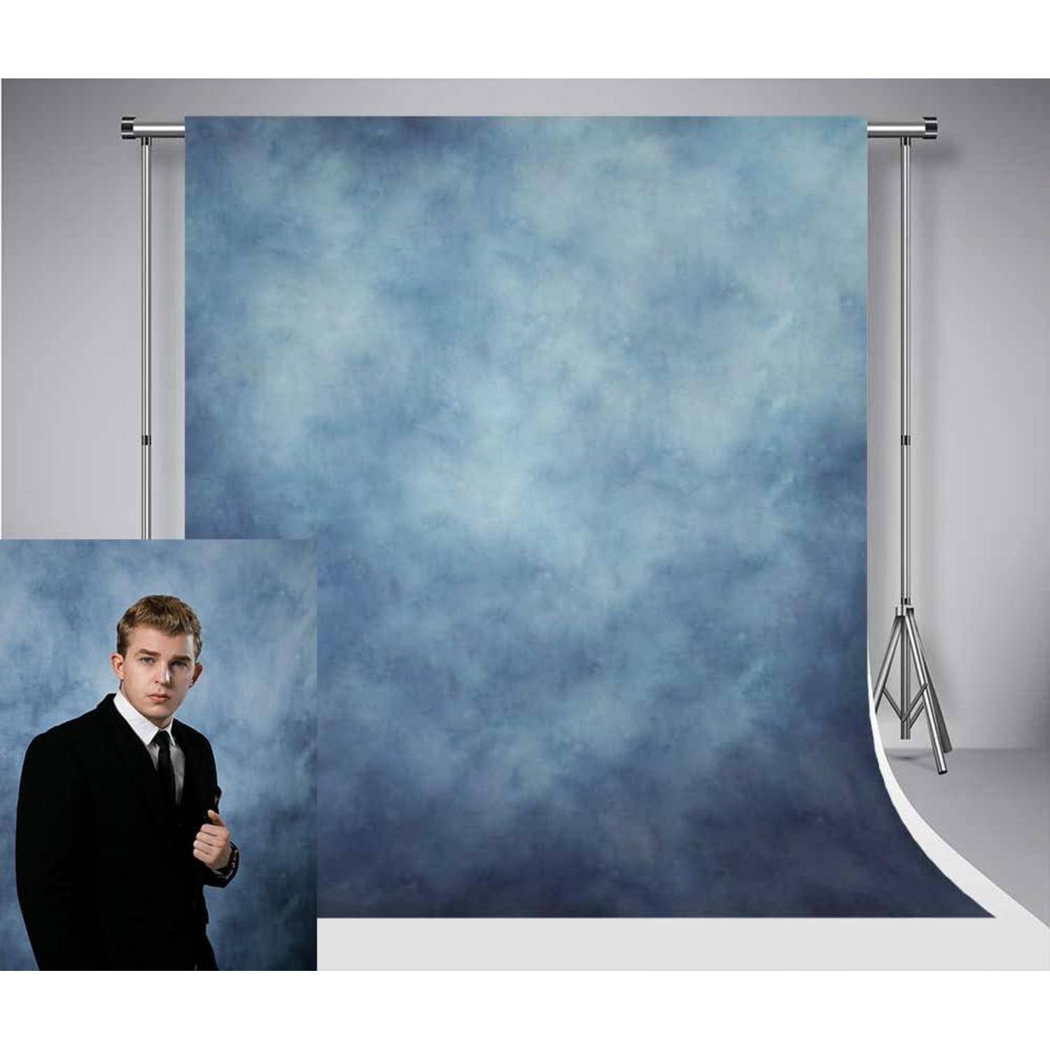 Eine Person in formeller Kleidung steht vor einem großen blauen Hintergrund.