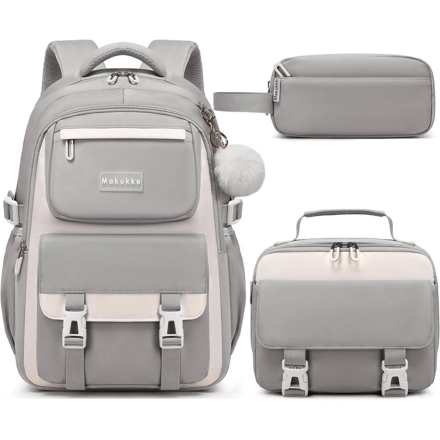 Grauer Rucksack-Set mit zwei Zusatztaschen, ausgestattet mit mehreren Taschen und Reißverschlüssen. Der Hauptrucksack hat einen Bommel-Schlüsselanhänger befestigt.