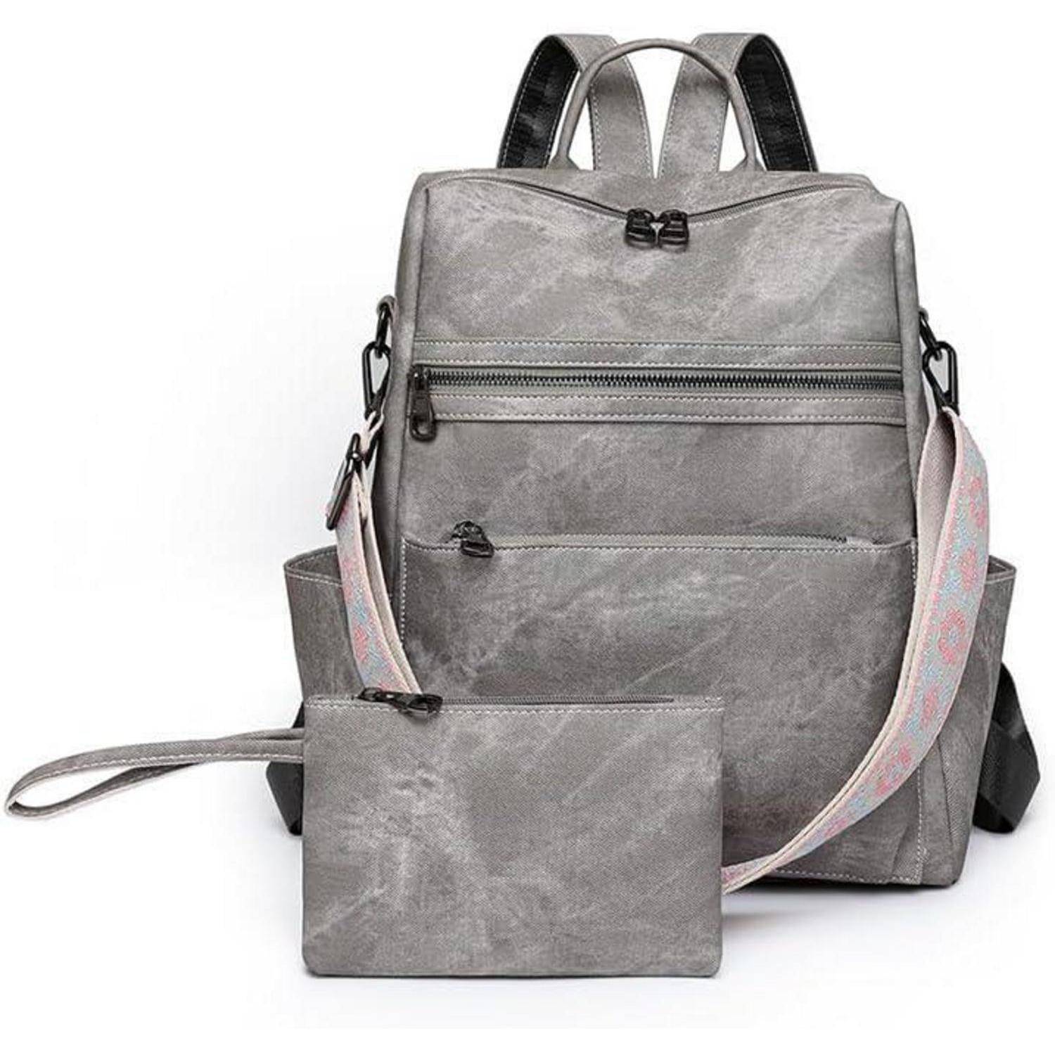Grauer Rucksack mit mehreren Taschen, Reißverschlüssen und einer passenden Tasche. Ausgestattet mit einem rosa Gurt mit einem dezenten Muster.