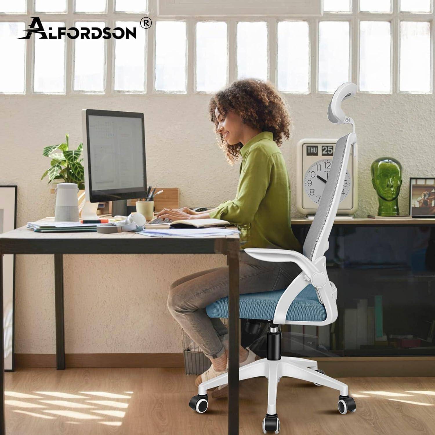 Eine Person sitzt an einem Schreibtisch in einem modernen Büro und arbeitet an einem Computer, während sie Notizen macht. Ein großes Fenster sorgt für natürliches Licht.
