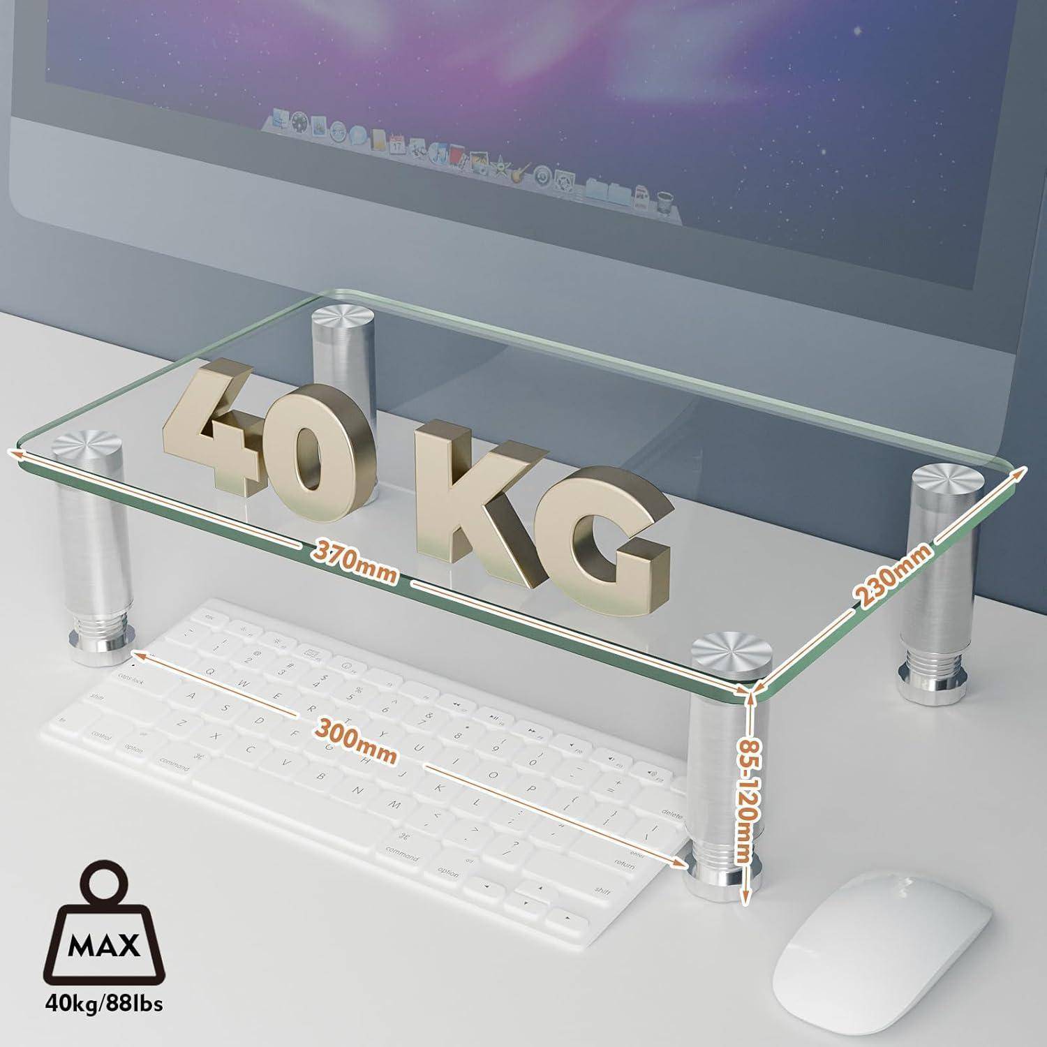Ein Monitorständer aus Glas trägt auf der Oberseite die Beschriftung '40 KG', was die maximale Gewichtsbelastung anzeigt. Abmessungen: 370 mm breit, 230 mm tief, 85 mm hoch. Darunter passt eine Tastatur.