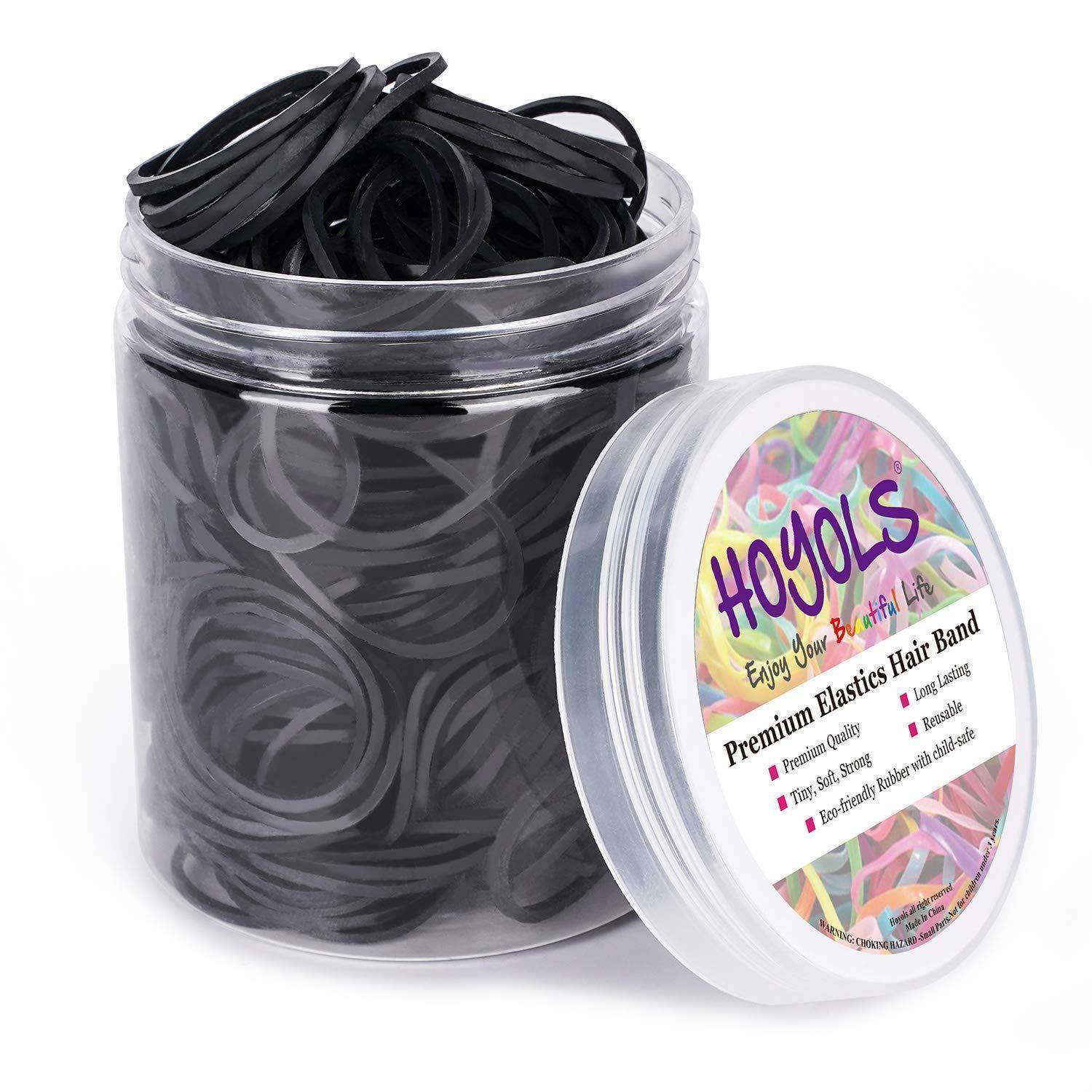 Ein durchsichtiges Glas gefüllt mit schwarzen elastischen Haarbändern, beschriftet mit 'Hoyols Premium Elastics Hair Band', mit bunten Haarband-Bildern auf dem Deckel.