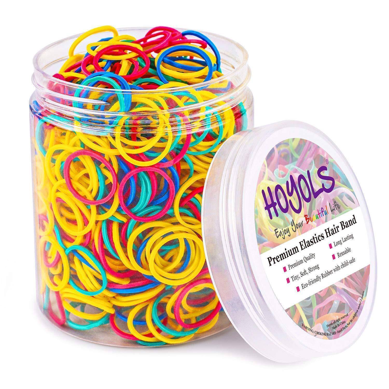 Ein durchsichtiger Plastikbehälter gefüllt mit bunten elastischen Haarbändern. Das Etikett trägt die Aufschrift „Hoyols Premium Elastisches Haarband