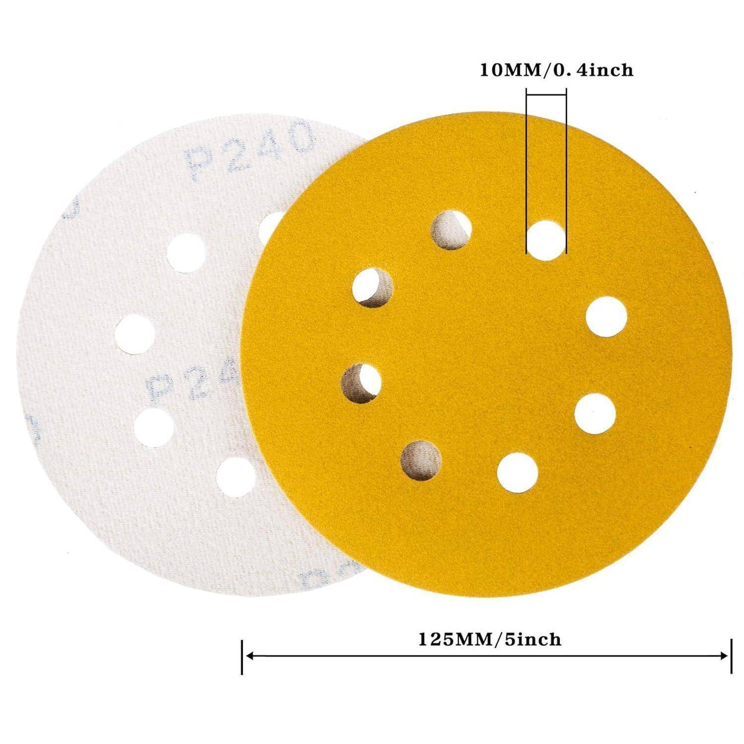 Runde Schleifpapier-Scheiben, eine gelb und eine weiß, jeweils mit mehreren Löchern. Ein Lineal markiert ihren Durchmesser mit 125 mm/5 Zoll und die Lochgröße mit 10 mm/0,4 Zoll.