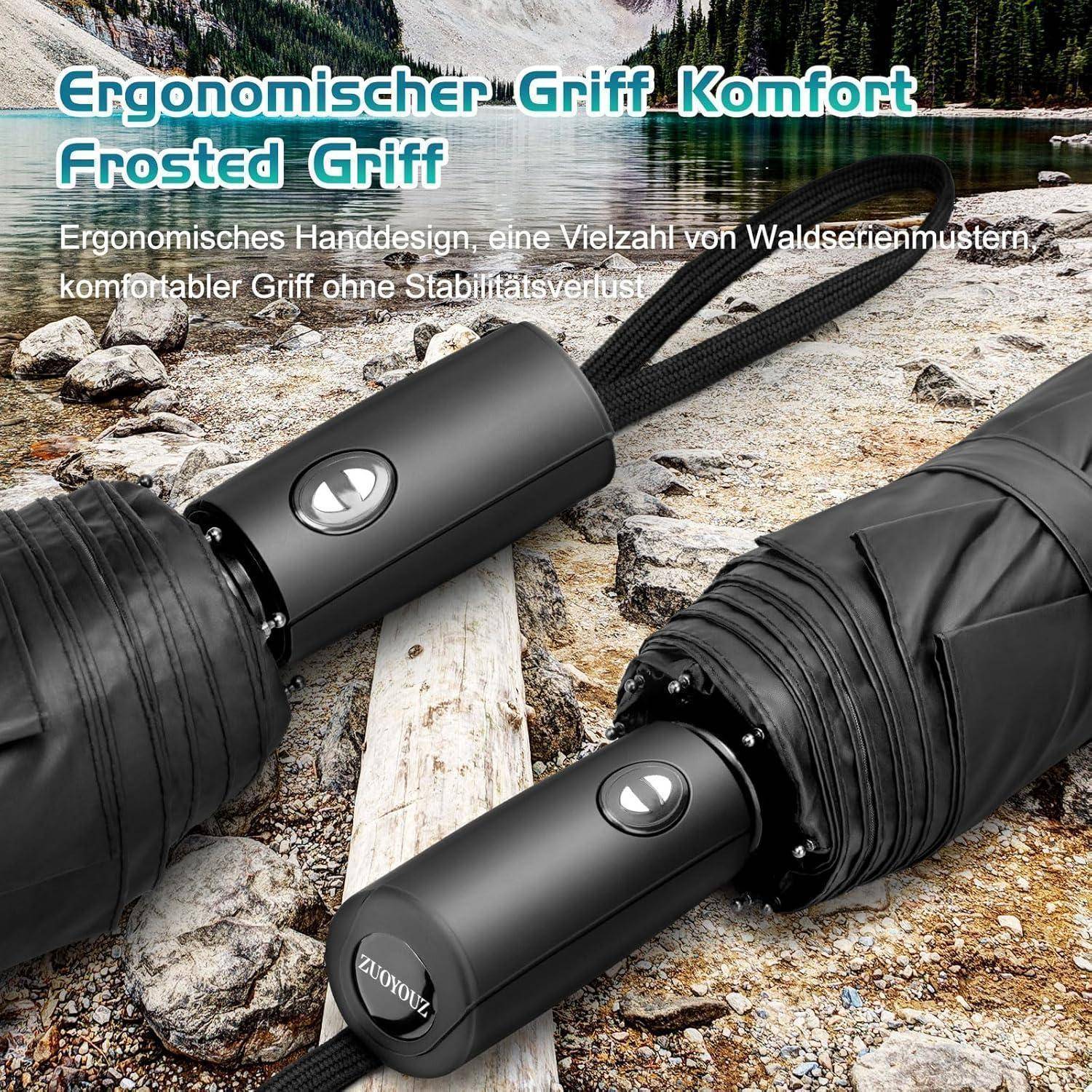 Ergonomischer Griff, Komfort Frosted Griff' Regenschirm, der auf felsigem Flussufer mit Wald im Hintergrund platziert ist.