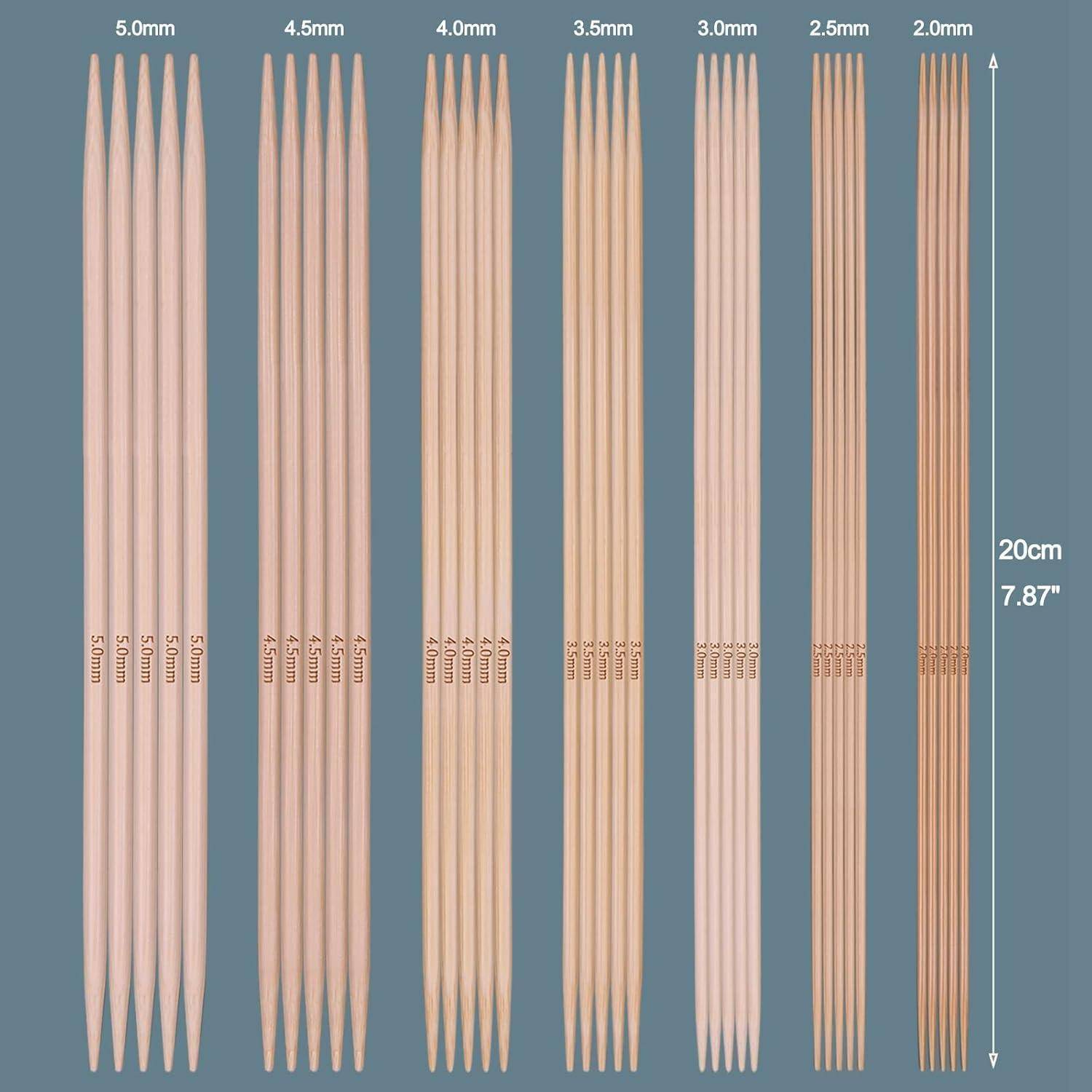 Ein Set Holz-Stricknadeln mit Spitzen an beiden Enden in verschiedenen Größen von 2,0 mm bis 5,0 mm, nach Größe gruppiert, horizontal angeordnet.
