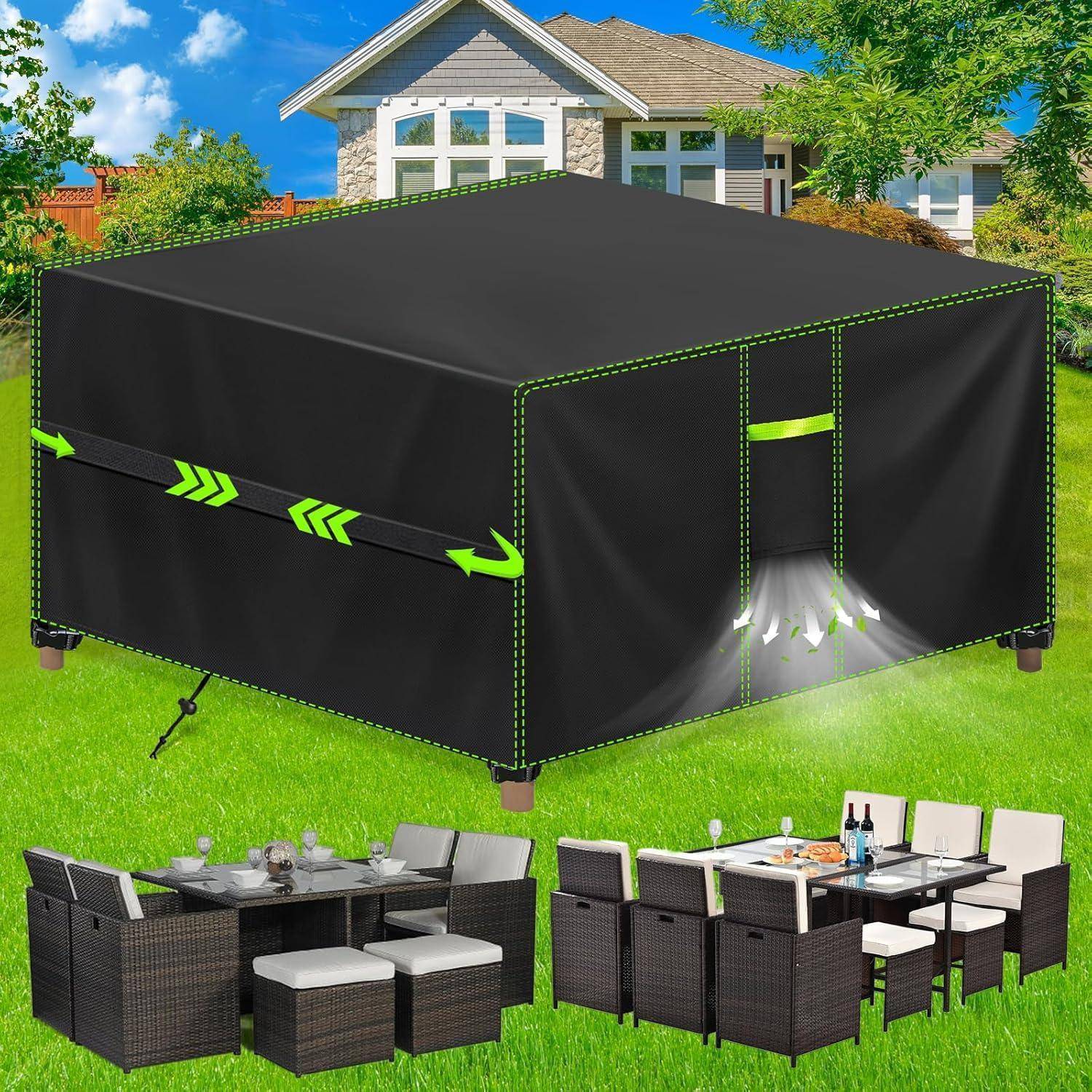 Gartenumgebung im Freien mit zwei Terrassensitzgruppen neben einer großen quadratischen schwarzen Möbelabdeckung auf einem Rasen und einem Haus im Hintergrund.